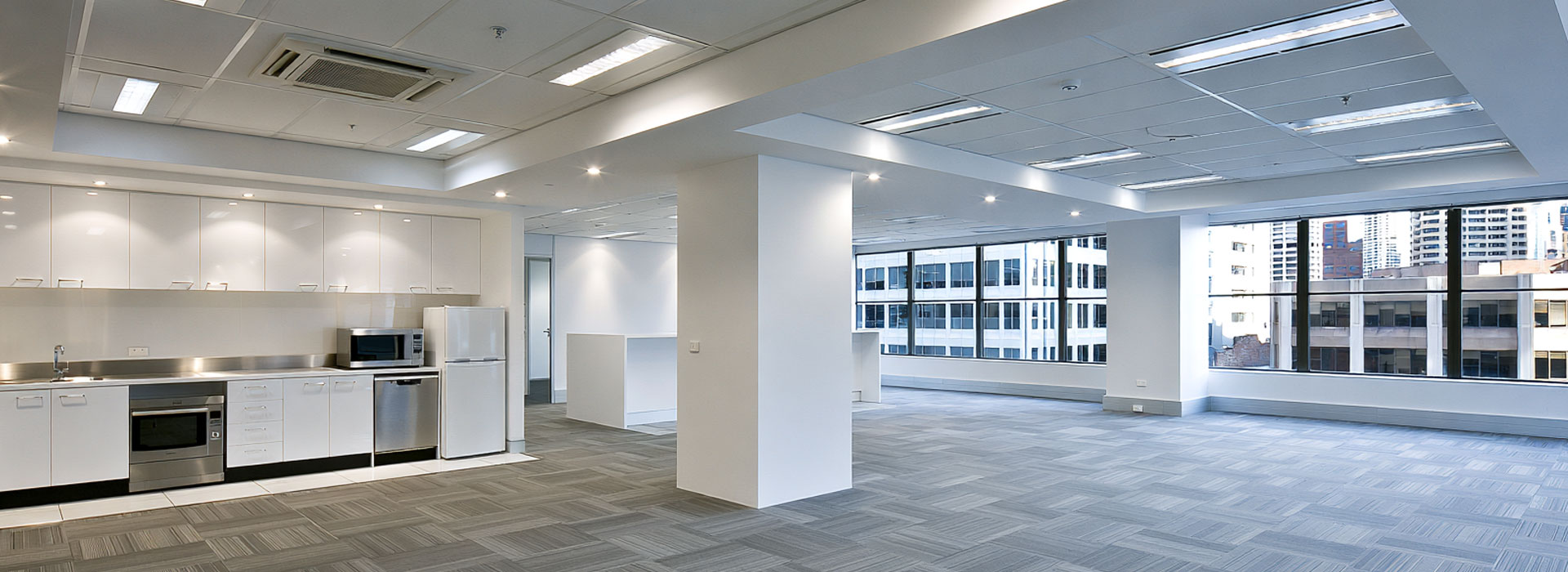Contemporary Sydney commercial office interior after a professional electrical upgrade, balanced architectural LED lighting, clean ceiling lines, practical modern workspace